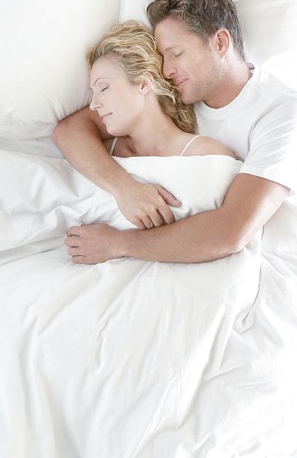 Teen Couple Snuggled Up In Bed